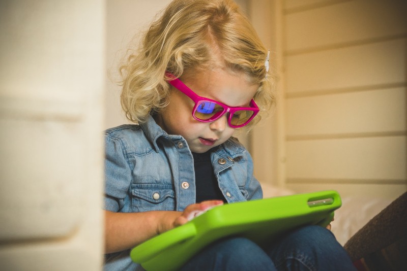 The Screen Sunglasses offer 100% protection against UVA/UVB rays Child wearing Real Shades Screen Sunglasses