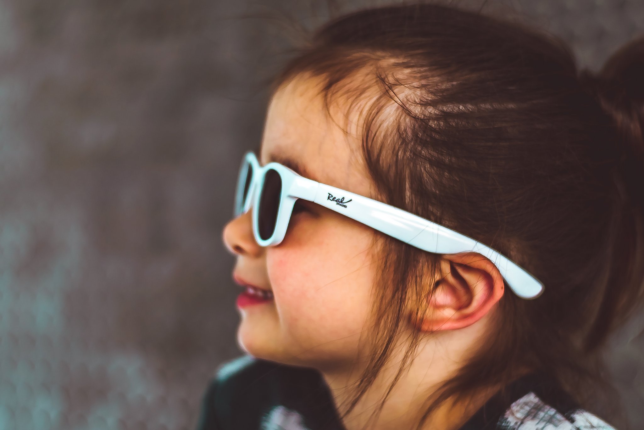 The Surf Sunglasses feature unbreakable frames and shatterproof lenses Child wearing Real Shades Surf Sunglasses