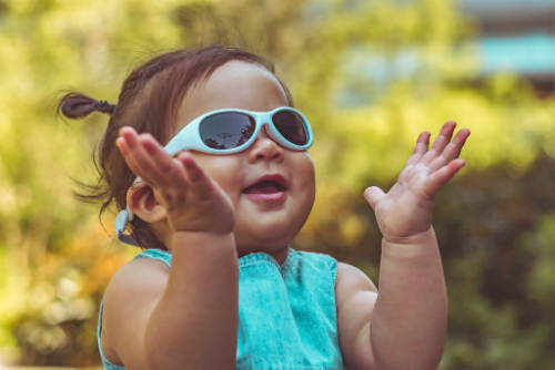 The Explorer Shades have a wraparound design that better protects your child's eyes Child wearing Real Shades Explorer Sunglasses